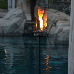 Big Revo Tiki Torch in a beautiful backyard setting around the pool